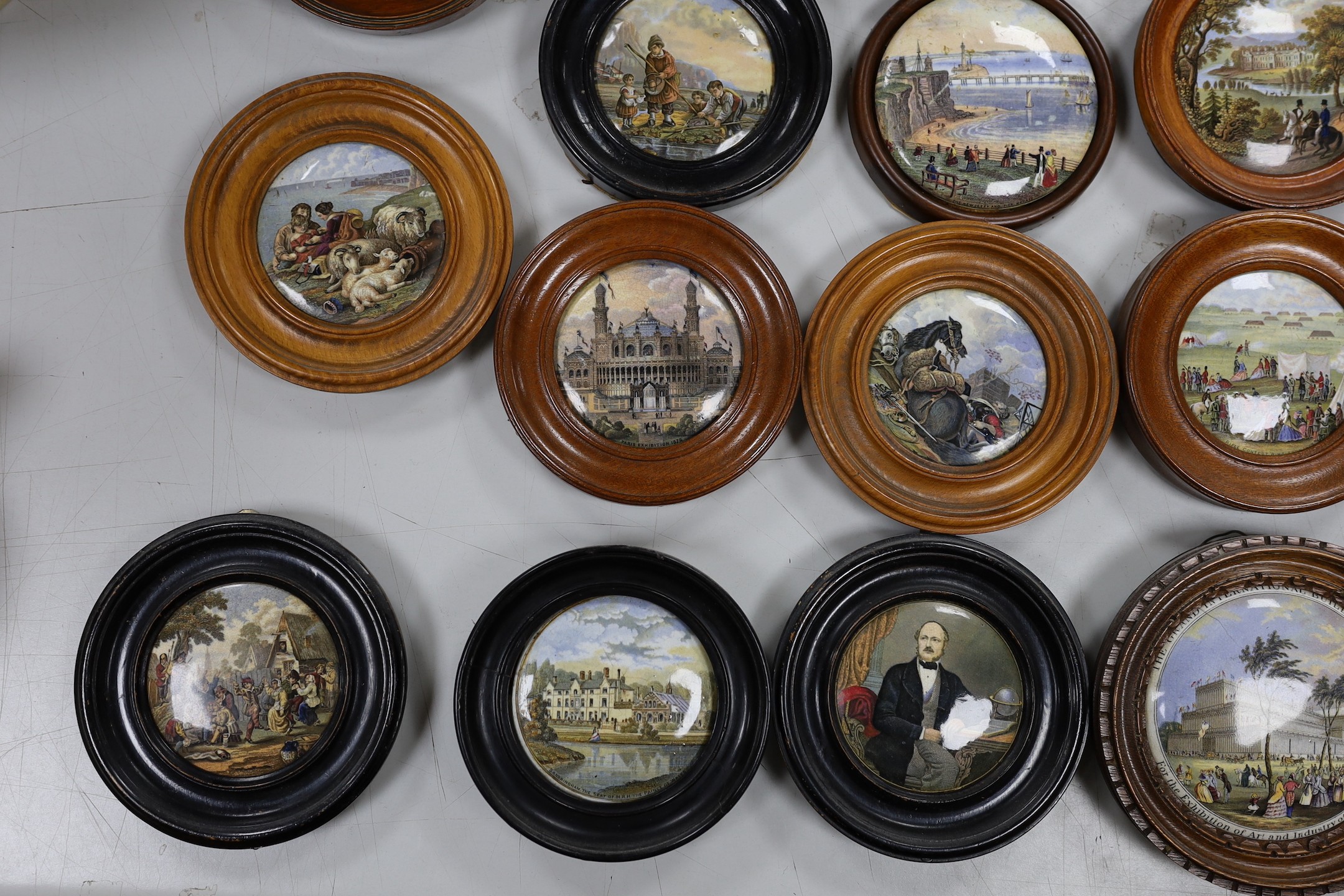 A collection of 19th century Prattware pot lids (23)